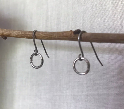 CHARM EARRING COMPONENT HANGING FROM A TWIG