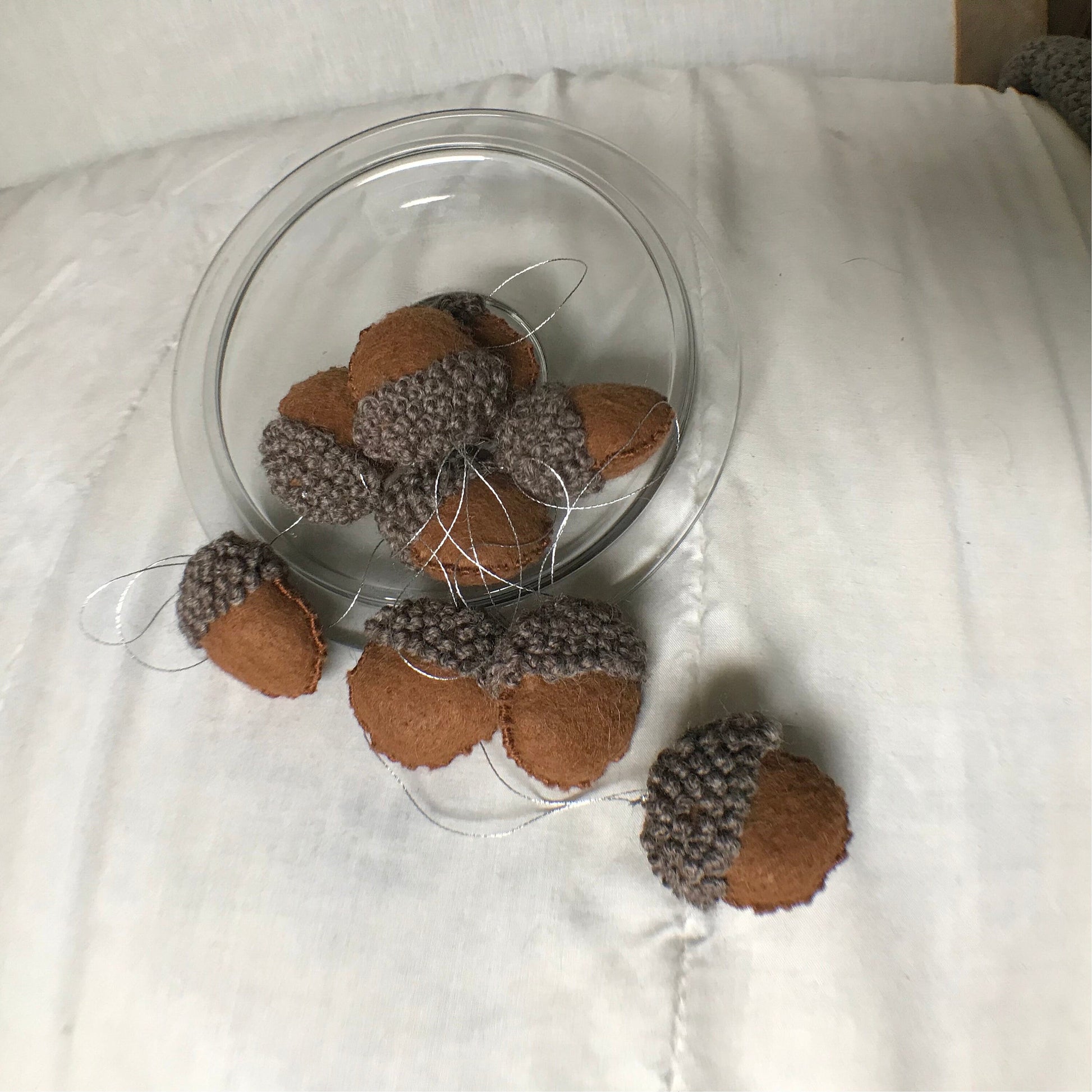 MULTIPLE ACORN EMBROIDERED ORNAMENT SPILLING OUT OF GLASS BOWL